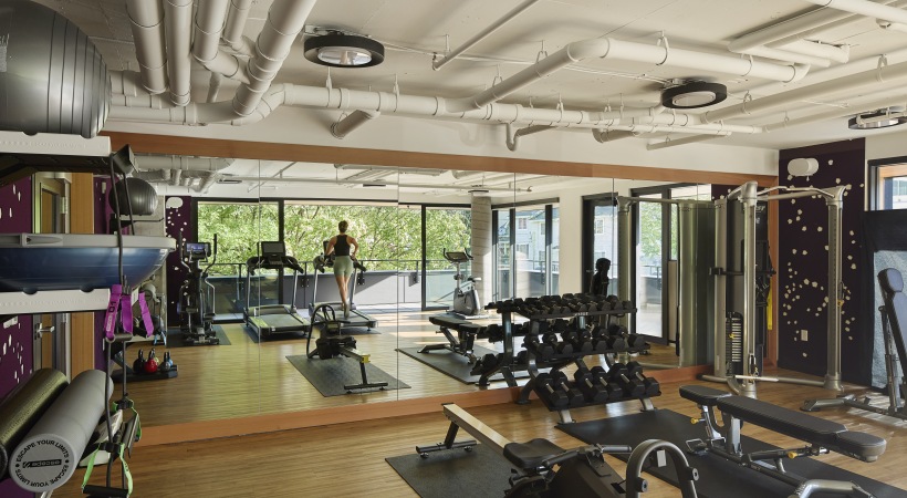 Fitness studio with cardio equipment, weights & yoga space